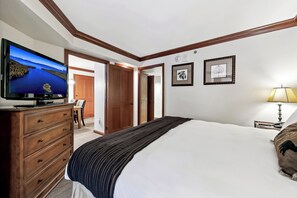 A hotel room with a large bed, a dresser, a television displaying a scenic view, and a framed picture on the wall. - Located @ Everline Resort & Spa, Pools/Spas/Golf/Ski-in&out/Sledding/Ice Skating (Olympic Valley)