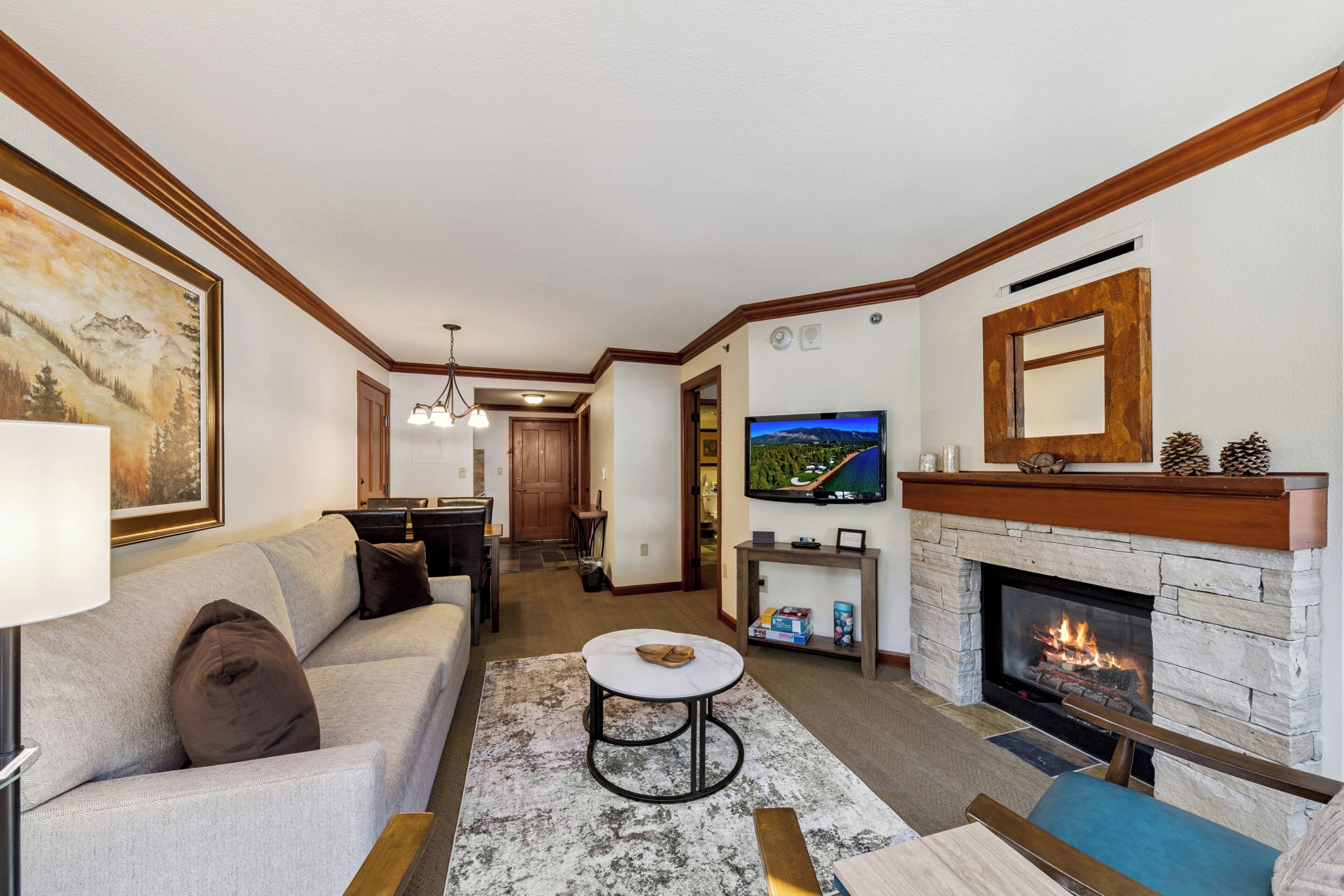 A living room with a fireplace, a television, and a sofa.