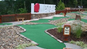 A miniature golf course with a sign for Hole 6, a wooden bench, and a sign that reads "I ♥ WESTCHESTER". - 2BR with Great Mountain views Master Suite and JR suite (Gatlinburg)