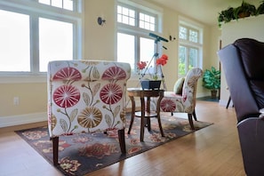 A living room with a floral-patterned sofa, a wooden coffee table, and a potted plant.