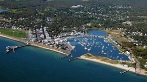 An aerial view of a coastal town with a marina, residential areas, and a bridge. - "The Carousel House" - Ocean Park - Featured in New York Times (Oak Bluffs)