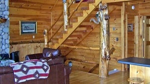 A wooden cabin interior with a staircase, a couch, and a table. - 'Endless View' from the Top of Sunrock Mountain (Blue Ridge)
