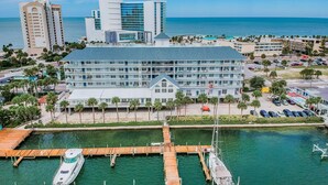 A waterfront hotel with a dock, multiple boats, and a clear view of the ocean. - Dockside 504 with private balcony and beautiful views (Clearwater)