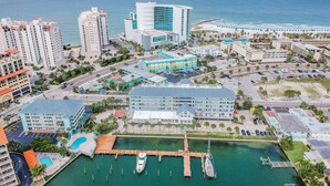 An aerial view of a coastal city with a marina, hotels, and a beach. - Dockside 504 with private balcony and beautiful views (Clearwater)