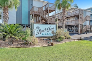 A beachfront hotel with a sign reading "The Beach Front."