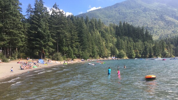A lake with people swimming and boats on the water. - The Perfect Cottage For A Family Vacation At The Lake (Cultus Lake)
