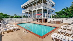 A pool area with multiple lounge chairs, a hot tub, and a covered seating area with a bar. - Semi-Soundfront Dog Friendly w/ Pool, Hot Tub, Game Room, Community Boat Ramp (Salvo)