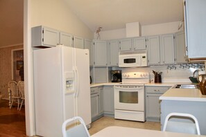 Enjoy cooking and dining in this fully equipped kitchen with a refrigerator, oven, microwave, and sink.