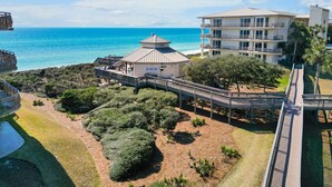 A coastal hotel with a beach view, a covered outdoor area, and a multi-story building with balconies.