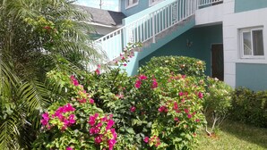 A two-story building with a blue exterior and white trim. - Cedar Pine Villas - Quiet, 'Luxury & Comfort Rolled Into One' (Nassau)
