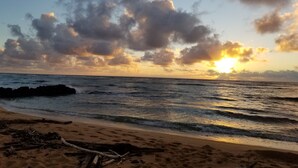 A beach with waves, a sunset, and clouds. -  Luxury Ocean Front Property!  Ocean& pool view.  B204  (Kapaa)
