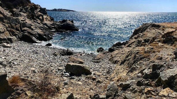 A rocky shoreline with clear blue water and a distant landmass. - Jamestown: Cozy Coastal Cottage in town near beaches & Newport, dogs OK! (Jamestown)