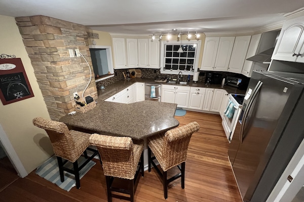 Gourmet kitchen w/ plenty of counter space wine fridge, wet bar, breakfast bar