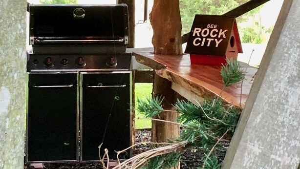 An outdoor kitchen area with a grill, oven, and hanging light fixtures. - Unique farm guest house close to Chattanooga, TN- great for families and dogs (Chickamauga)