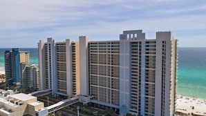 A high-rise hotel with multiple floors, a beach view, and a parking structure. - 1 Bedroom in Majestic Beach Resort - Low floor, Spacious and bright and beautifully decorated! (Panama City Beach)