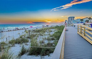 Stroll along the beachside promenade, lined with beach chairs and umbrellas, and enjoy the lively atmosphere.