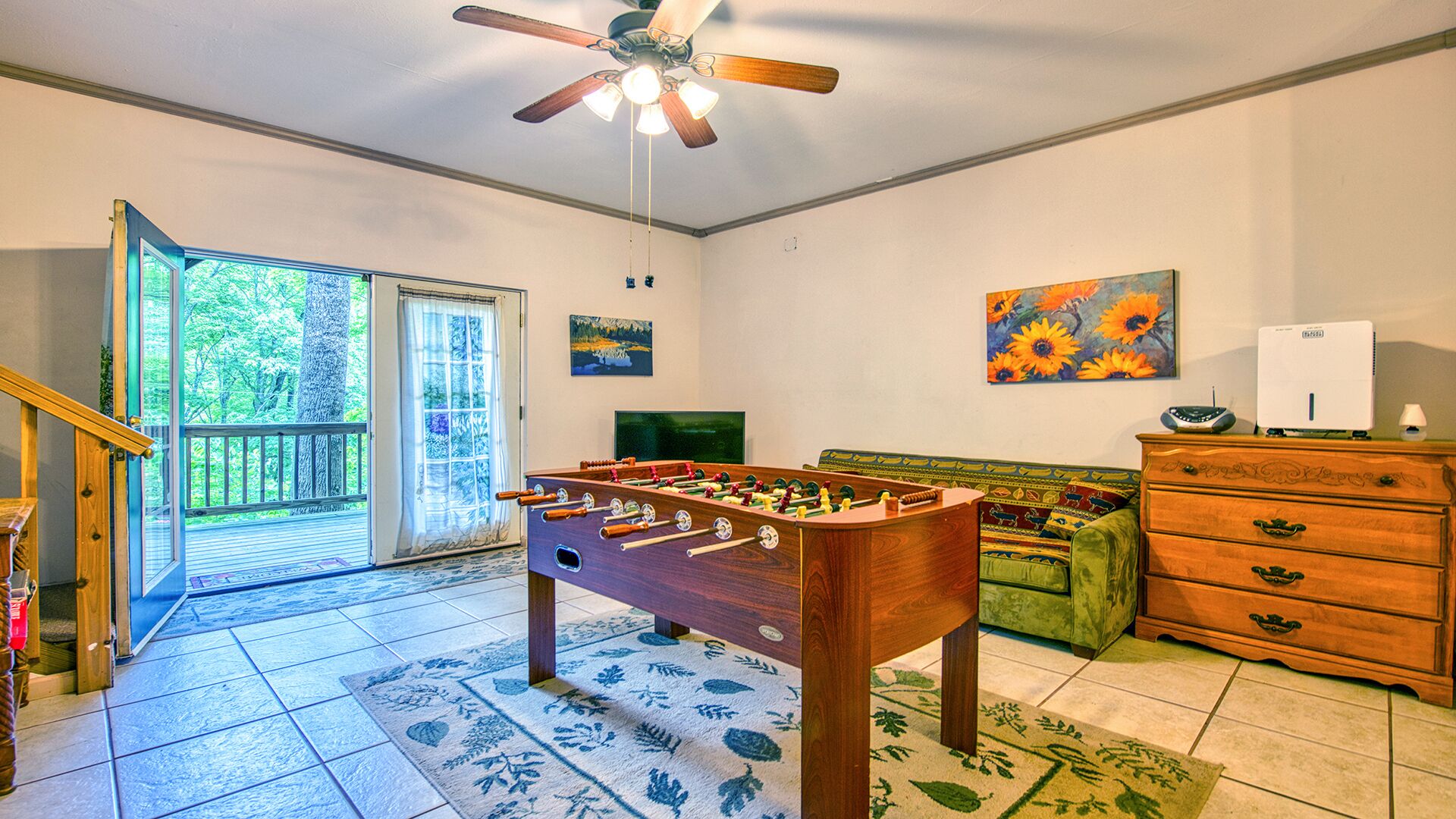 Game room with foosball Table and French doors to lower deck and hot tub