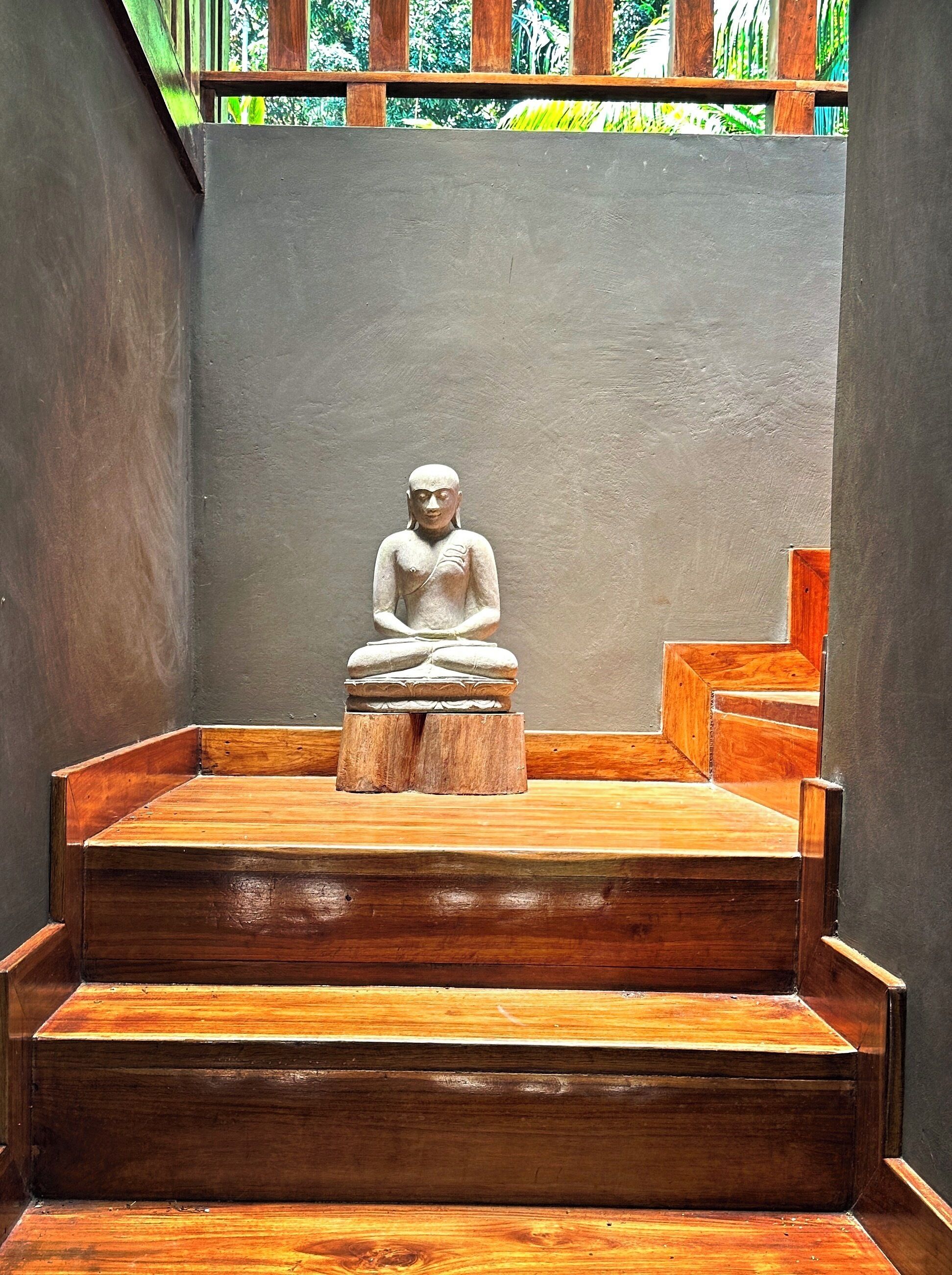 A statue on a wooden platform with steps leading up to it.