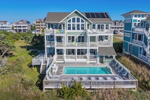 A multi-story beachfront property with a swimming pool and outdoor seating. - Soundfront Salvo Home w/ Saltwater Pool, Hot Tub, Elevator, Theater, Tiki Bar (Salvo)