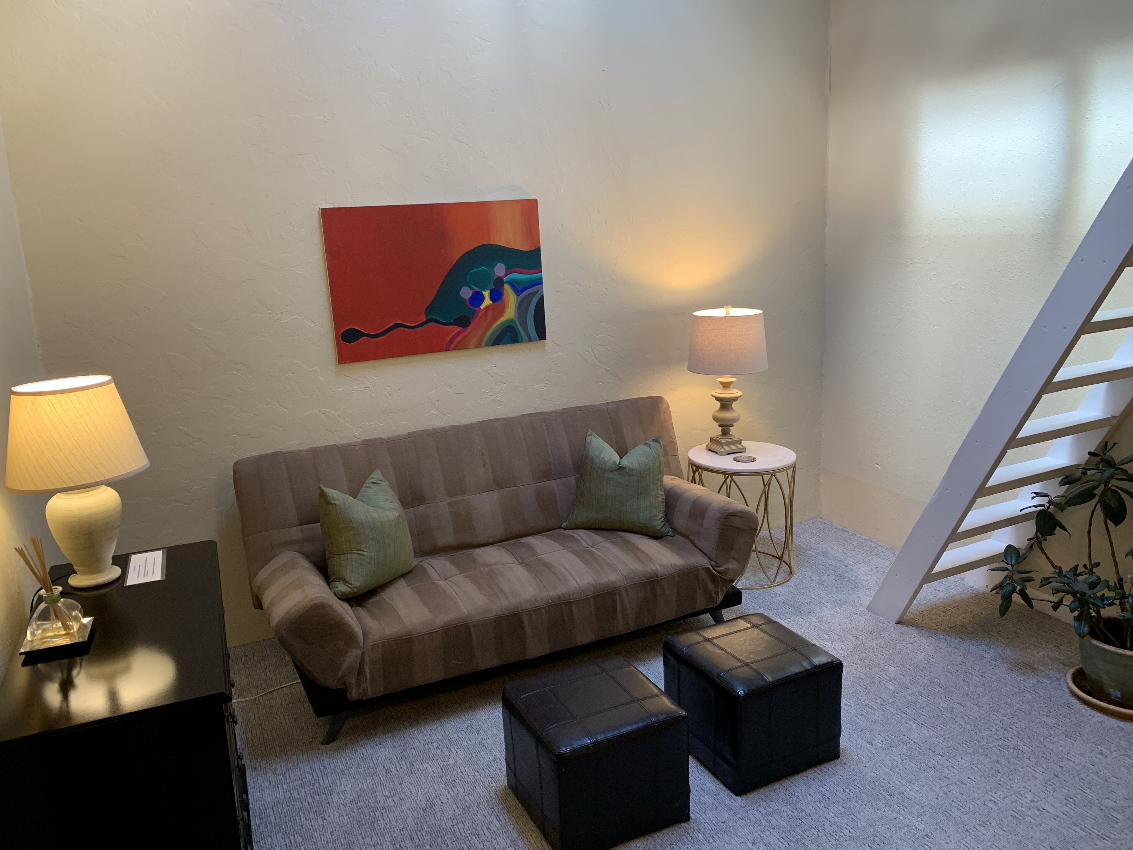 Den area showing ladder to loft