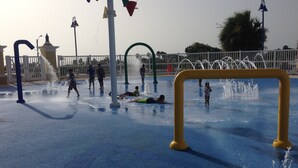 A water play area with multiple water jets and a yellow safety barrier. - El Faro Surf House!!  Less Than 2 mi From Airport And Surf (Aguadilla)