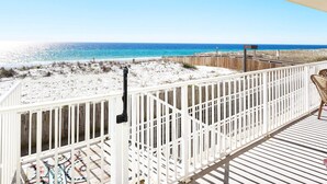A wooden deck with a white railing overlooking a beach. - Sea Dunes • Oceanfront Balcony w Convenient Direct Access, Pool, Hot Tub, Free Beach Service (Fort Walton Beach)
