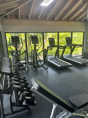 A gym with treadmills, ellipticals, and dumbbells. - Henry's Piece of Paradise on the Ocean in Key West - Weekly / Nightly (Key West)