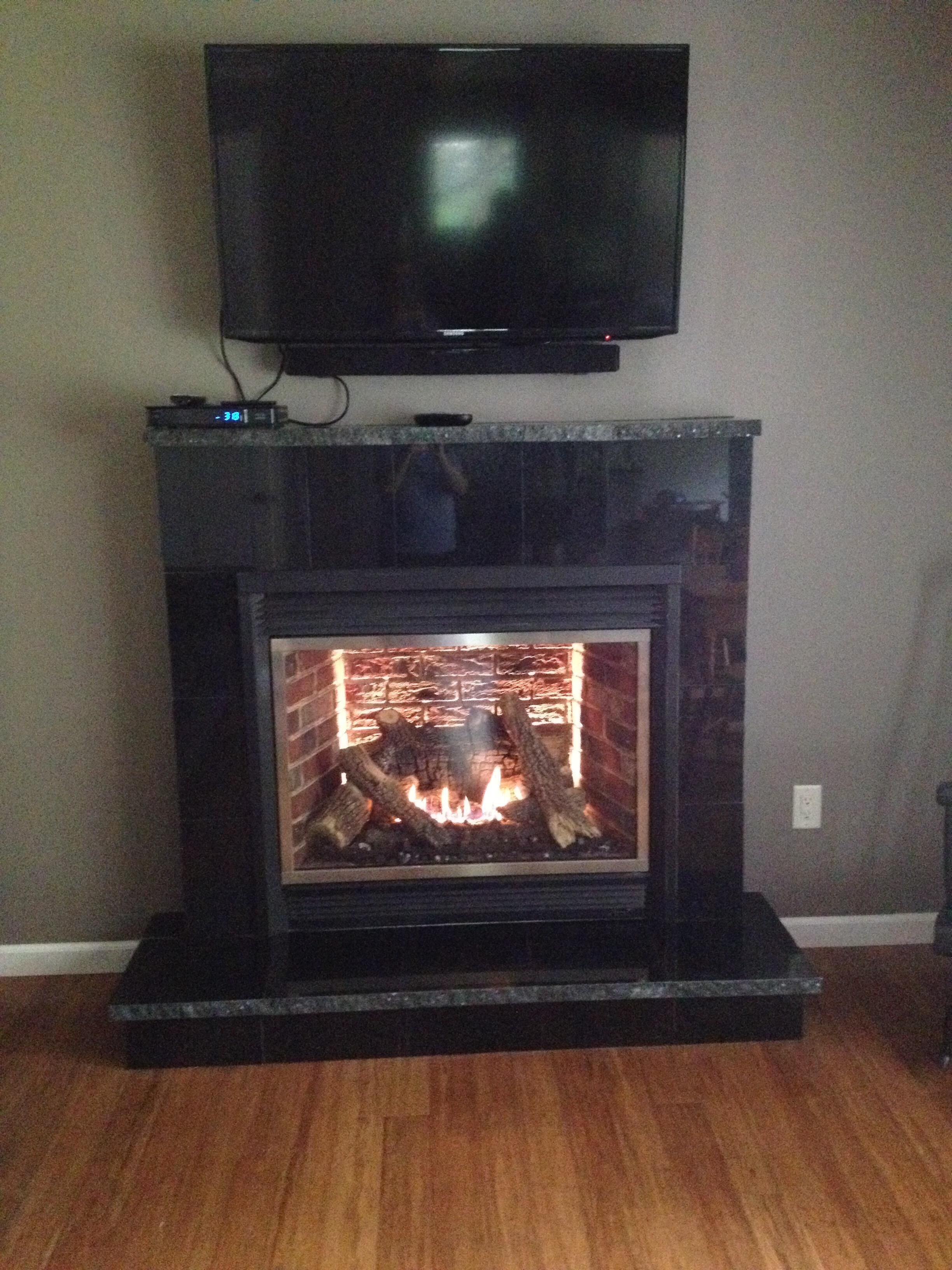stay warm & cozy by the fireplace with large screen TV above