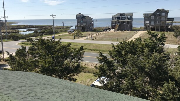 A coastal view with two large houses, a road, and a beach. - Spectacular Sound & Ocean Views, OBX 3BR2BA House, sleeps 8, dog friendly (Frisco)