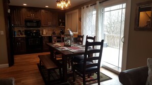 A kitchen with wooden cabinets, a microwave, and a dining area with a table set for four. - Newly remodeled, Located in Galena Territories. Small dogs OK under 25 LBS  (Galena)