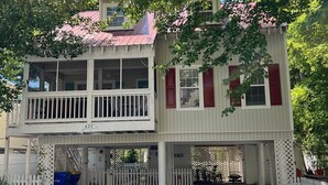 A two-story house with a balcony, a red roof, and a white fence. - Perfect Key West Style - Golf -Tennis - Pet Friendly (Bethany Beach)