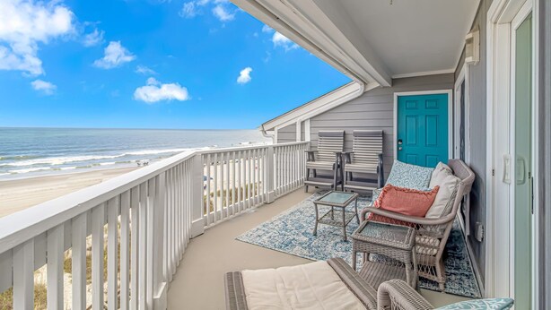 A balcony with a view of the beach, a door, and two wicker chairs with cushions. - Come on down! Great weather, comfortable furniture and beds! 
Best view! (Surfside Beach)