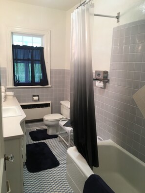 A bathroom with a toilet, sink, and bathtub. - 1928 Home in the heart of Cumberland Gap (Cumberland Gap)