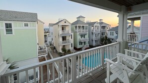 A multi-story residential building with a balcony, a swimming pool, and a view of the ocean. - Poolside House w/ Ocean Views, Steps from Beach & Restaurants (Atlantic Beach)