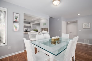 Enjoy meals in this stylish dining area with a glass-top table and comfortable seating.