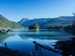 A tranquil lake surrounded by forested mountains. - Cozy, clean, updated cabin w/hot tub, fireplace, fire pit, BBQ, smart TV (Packwood)