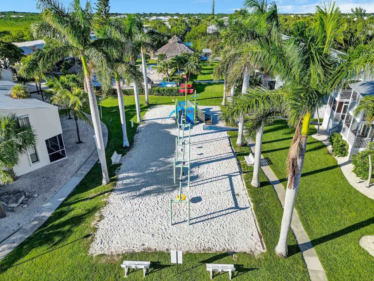 A playground with a slide, climbing structures, and a small shelter.