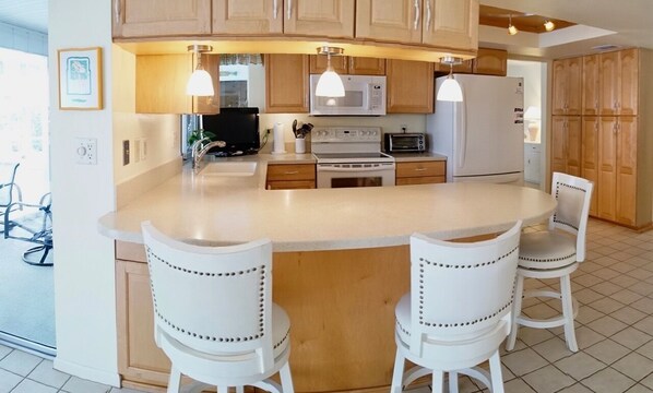 Enjoy cooking in this well-equipped kitchen with a central island and bar stools.