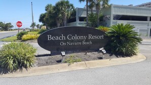 A sign for Beach Colony Resort on Navarre Beach. - Beach Colony West 8E Beautiful Gulf Views from over sized balcony (Navarre)