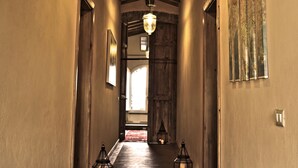 A hallway with wooden floors, a wooden ceiling, and hanging lanterns. - FABULOUS 4BD HOME IN CAPALBIO W/ PRIVATE POOL & GARDEN, MINUTES TO THE BEACH! (capalbio)