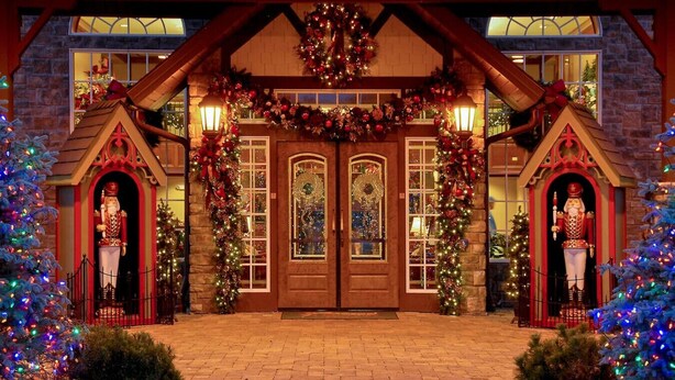A building with a brick facade, a wooden entrance with a large door, and two small towers with nutcracker statues. - Hillbilly Hotel, Great Resort, Great Game Room (Sevierville)