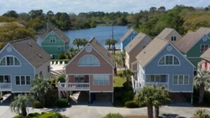A residential area with houses featuring gabled roofs and front yards. - Beautiful Oceanfront Condo On 4th Floor - Steps From The Beach. Linens Incl. !!! (Surfside Beach)