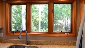 A kitchen with two windows, a sink, and a countertop. - Amazing Views at Dragonfly! HOT TUB! Kayaks, BOUNCER w Slide, SUP's, Fire Pit!  (Bracey)
