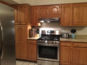 Enjoy cooking in this well-equipped kitchen with an oven, range, and ample countertop space.