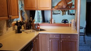 A kitchen with wooden cabinets, a sink, and a stove. - Beach House in Rehoboth Beach, DE (Rehoboth Beach)