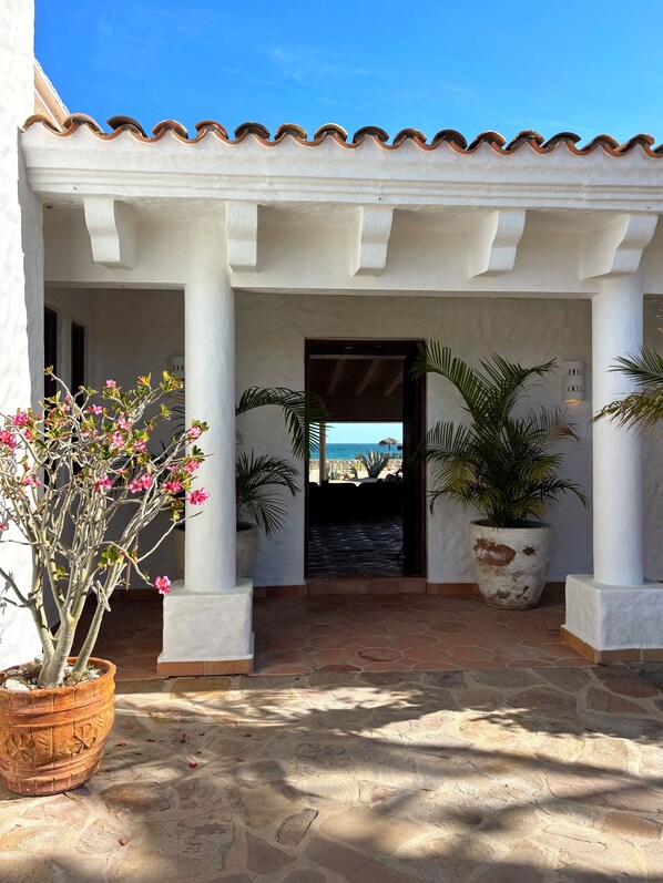 A covered patio area with white columns, a stone floor, and potted plants. - Beachfront, La Ribera,  Sea of Cortez, Costa Palmas, 4 Seasons, East Cape (La Ribera)