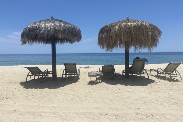 Private beach,with chaises and sombra in front of house.