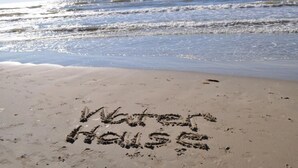 A beach with the words "Water House" written in the sand. - Beach Front Home, Huge Deck, Sleeps 12 (Crystal Beach)