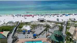 A beach resort with a pool area, lounge chairs, and umbrellas. - True 1 BR with full kitchen, Luau 6532 by Skis and Seas | South Gulf facing (Destin)