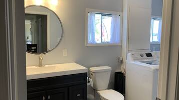 Bathtub, hair dryer, soap, toilet paper